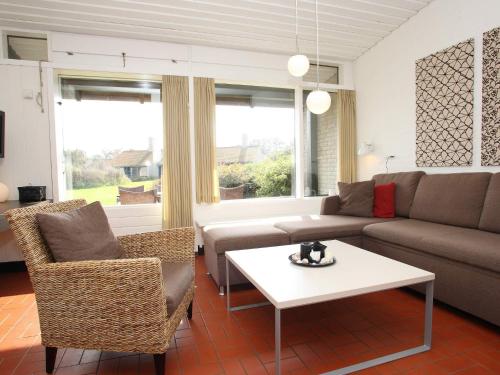 a living room with a couch and a table at 6 person holiday home on a holiday park in Sæby in Sæby