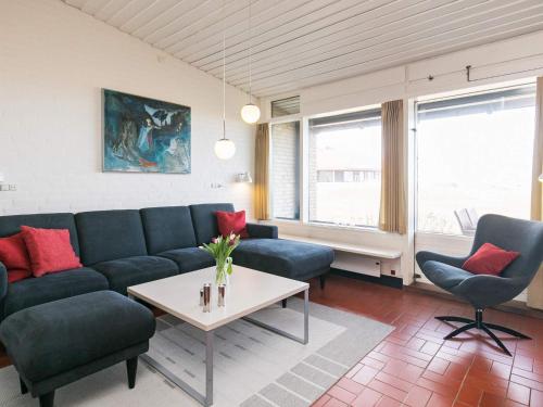 a living room with a couch and chairs and a table at 6 person holiday home on a holiday park in Sæby in Sæby