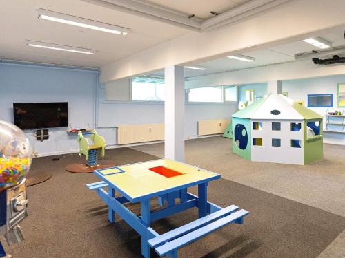 a play room with a table and a play house at Apartment with loft in Ringkøbing in Ringkøbing
