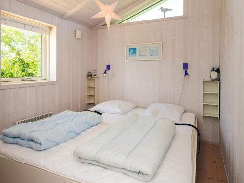 two large beds in a room with a window at 4 star holiday home in Hejls in Hejls