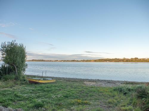 a boat sitting on the shore of a lake at Lodge playa pupelde, Ancud in Mecura
