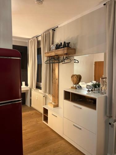 a kitchen with white cabinets and a refrigerator at Apartment Vita Cittadina in Klagenfurt