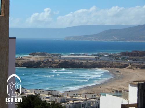 a view of a beach and the ocean at Eco Bay Surf Camp in Aourir