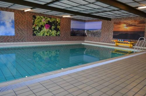 a large swimming pool in a building at 4 Personer Ferielejlighed - Henne Strand in Henne Strand