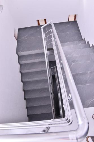 a staircase in a building with a metal railing at Apartments Kayaville in Sjenica