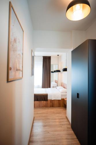 a small bedroom with a bed and a window at At George`s Stay&Fly in Otopeni