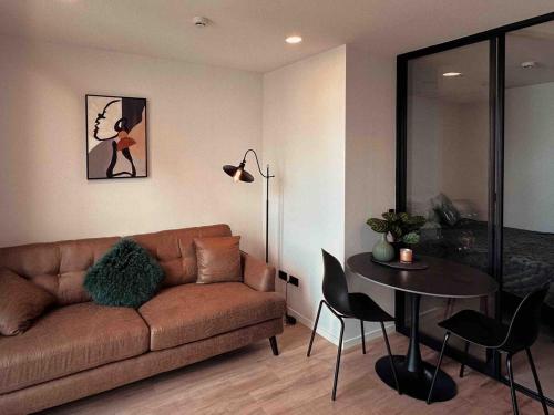 a living room with a couch and a table at Elegant City Center Stay, Stylish Living in Auckland