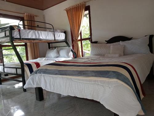 Postel nebo postele na pokoji v ubytování Curitagua Hotel Campestre