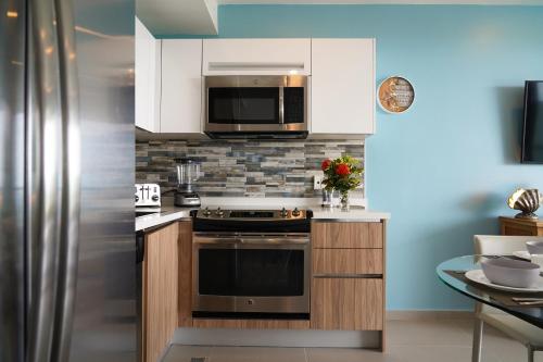 a kitchen with a stove and a microwave at Azure Beach Residences in Palm-Eagle Beach