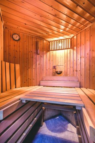 a wooden room with two beds in a sauna at Villa Roses Apartments & Wellness in Ičići