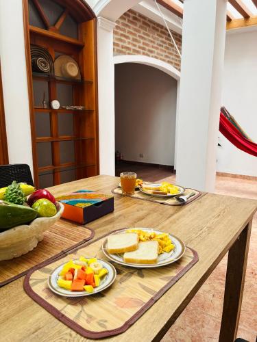 a wooden table with two plates of food on it at Paraiso Pie de la Popa in Cartagena de Indias