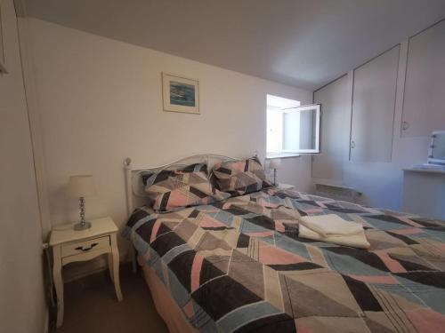 a bedroom with a bed and a table with a lamp at Sea View Holiday Home Umag - Three Bedroom Holiday Home in Umag
