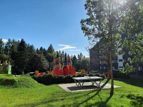 a picnic table in a park with a playground at Apartment mit Balkon im Ferienpark in Schöneck in Schöneck