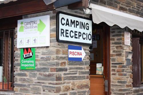 a building with signs on the side of it at Camping Gran Sol in Montferrer