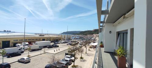 a view of a parking lot with cars parked at Apartamento na marina com vista 180º junto à praia in Setúbal
