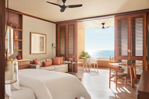 a bedroom with a bed and a view of the ocean at Four Seasons Resort Tamarindo, México in Cihuatlán
