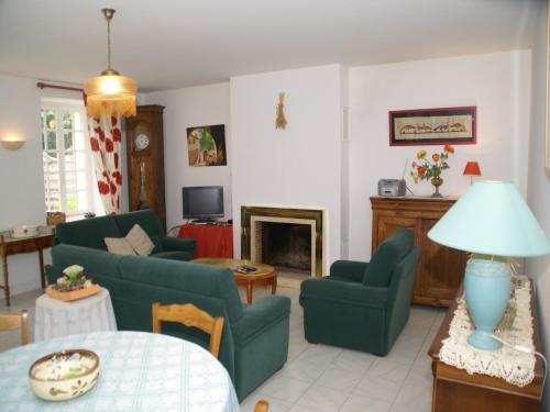 a living room with green furniture and a fireplace at Elegant Escape in Lanrelas in Lanrelas