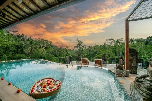 a pool at a resort with a view at Yoga Maya Villa in Gianyar