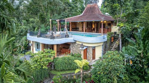 a house with a swimming pool on top of it at Yoga Maya Villa in Gianyar