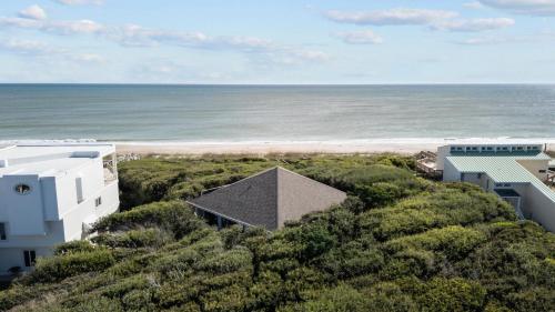 an aerial view of the beach and buildings at Beach Grove home in Pine Knoll Shores