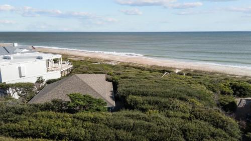 an aerial view of a house and the beach at Beach Grove home in Pine Knoll Shores