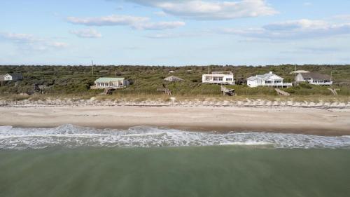 an aerial view of a beach with houses and the ocean at Beach Grove home in Pine Knoll Shores