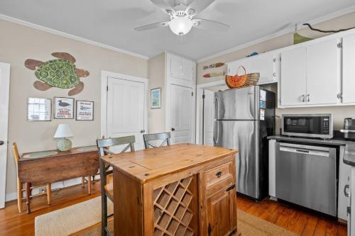 a kitchen with a refrigerator and a table and chairs at Condo on Front condo in Beaufort