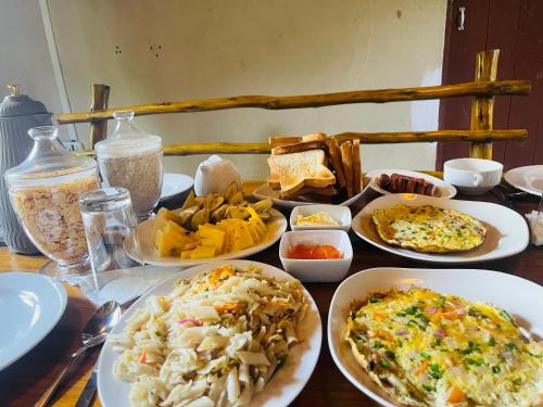 a table with plates of food on a table at The Lake Frost in Nuwara Eliya
