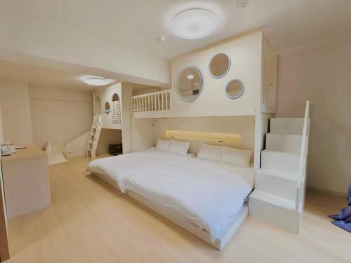 a bedroom with a white bed and a bunk bed at Rest Collection Bentencho Osaka in Osaka
