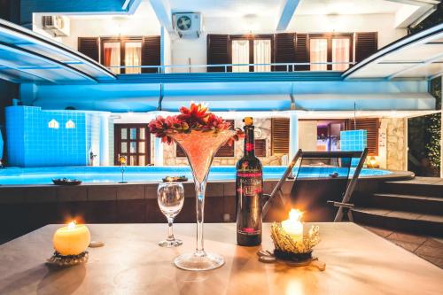 a table with a bottle of wine and two candles at Villa Roses Apartments & Wellness in Ičići