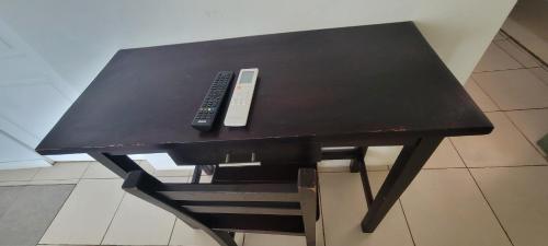 a black table with a remote control on it at Ocean View in Big Corn Island