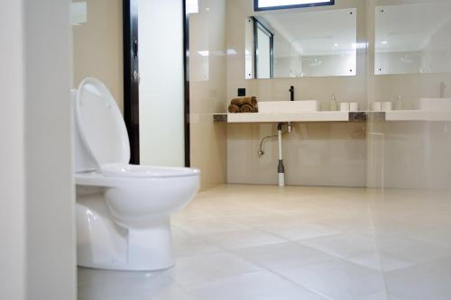 a bathroom with a toilet and a sink at Lush Tropical Villa Central Amed in Amed
