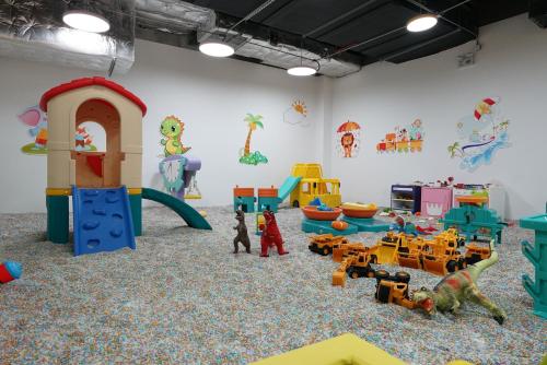 a room filled with lots of different types of play equipment at Arthur Hotel Liwan COCO Park Dongsha Metro Guangzhou-24H Coffee & Low Tea & Free Shuttle Bus For Canton Fair By Paco in Guangzhou