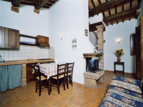 a kitchen with a table and a stove at Farmhouse in Proceno with Pool in Proceno
