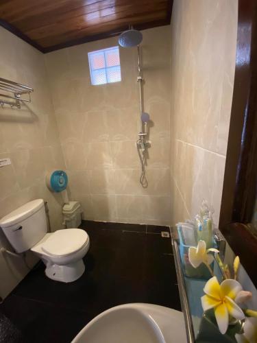a bathroom with a toilet and a sink and a shower at Golden Sun Hotel Luang Prabang in Luang Prabang