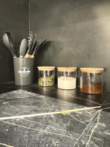 a counter with four jars of food on it at DiliNest near UWC College in Dilijan
