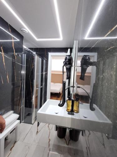 a bathroom with a white sink and a mirror at Hotel Aurora in Tivoli Terme