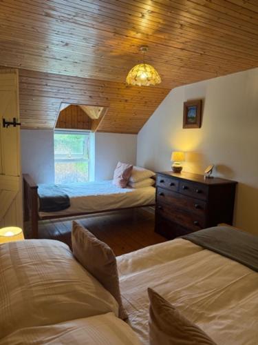 Postel nebo postele na pokoji v ubytování Tadpole Lodge
