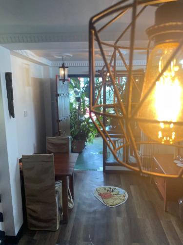 a living room with a wooden table and a lamp at Redwood Inn in Nuwara Eliya