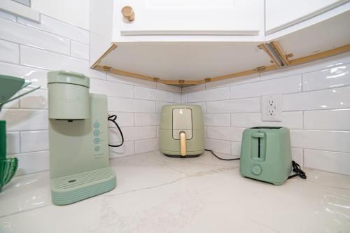 a kitchen with a sink with two devices on the counter at Cactus Cottage in Yuma