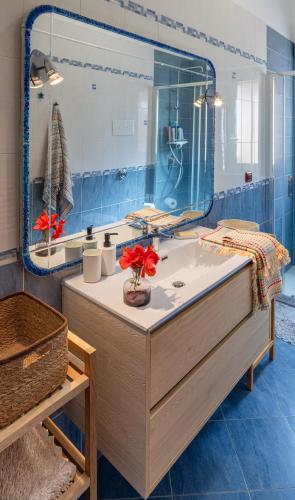 a bathroom with a sink and a large mirror at Villa Yasmine in Cinisi