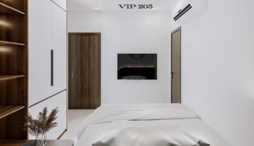 a bedroom with white walls and a bed in a room at Ha Giang Hill Hotel in Dồng Văn