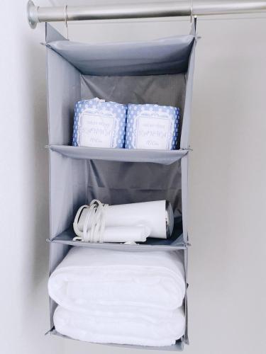 a towel rack with towels and toilet paper at ksi南常盤台402 in Tokyo