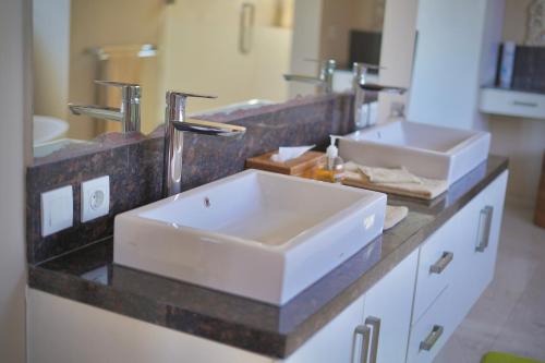a bathroom with a sink and two sinks on a counter at Villa Mandalika Lombok in Kuta Lombok
