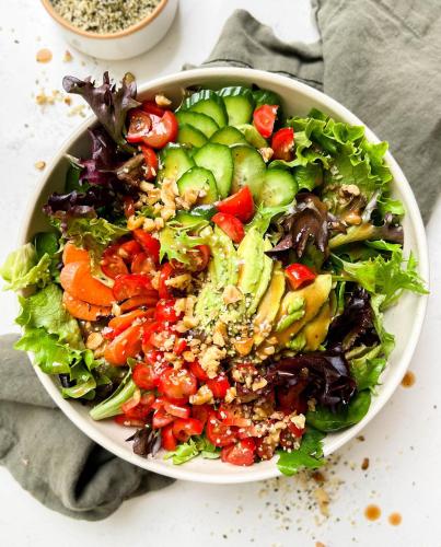 a salad in a white bowl on a table at Steps Garden Resort in Negombo