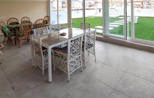 a dining room with a table and chairs at Awesome Apartment In Fuengirola in Fuengirola