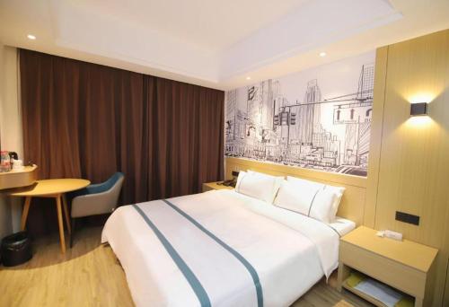 a hotel room with a large bed and a table at City Comfort Inn Changsha Sifangping University of National Defense Science and Technology in Changsha