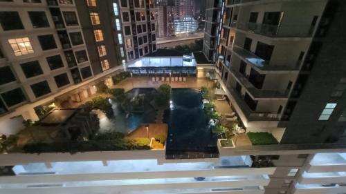 an aerial view of a pool in the middle of buildings at Summer Suites KLCC by CozyNest in Kuala Lumpur