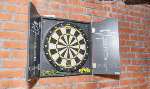 a dart board is attached to a brick wall at Lovely Holiday Home With Hot Tub 150 M To Water in Fur
