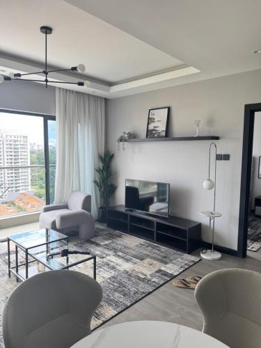 a living room with a couch and a table at 2BR WiFi pool gym free breakfast Westlands nairobi in Nairobi